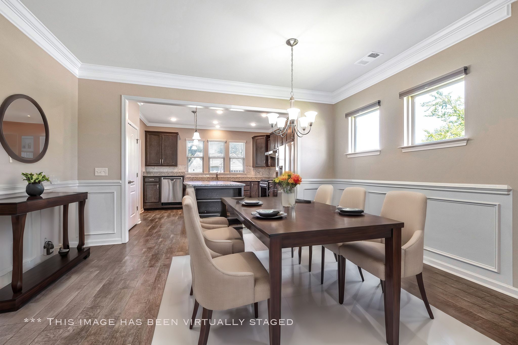 104 Tipton Pass Spring Hill, TN 37174 - Photo 13 of 57 a view of a dining room and livingroom with furniture wooden floor a rug a painting and a chandelier