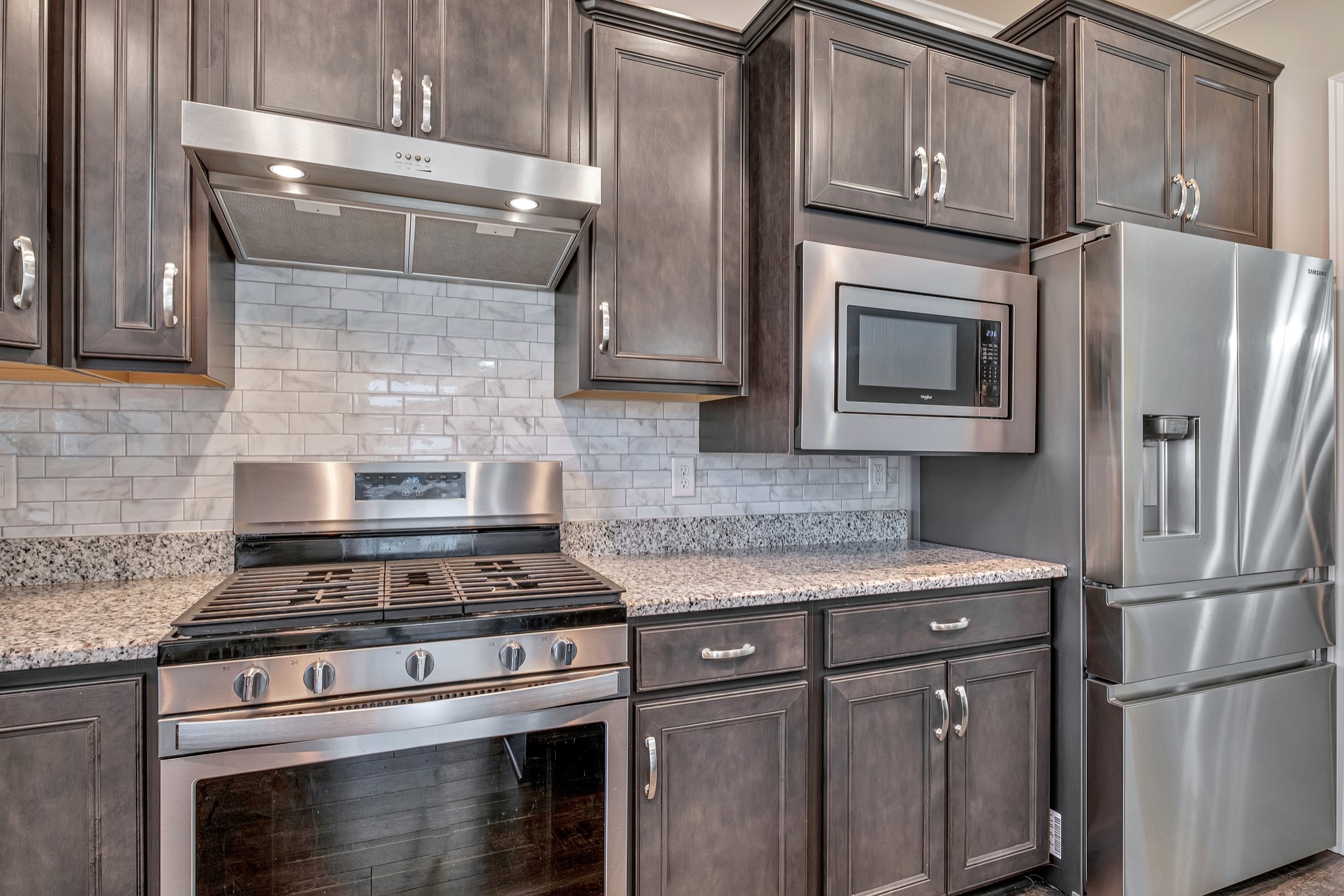 104 Tipton Pass Spring Hill, TN 37174 - Photo 17 of 57 a kitchen with stainless steel appliances granite countertop a stove and a refrigerator