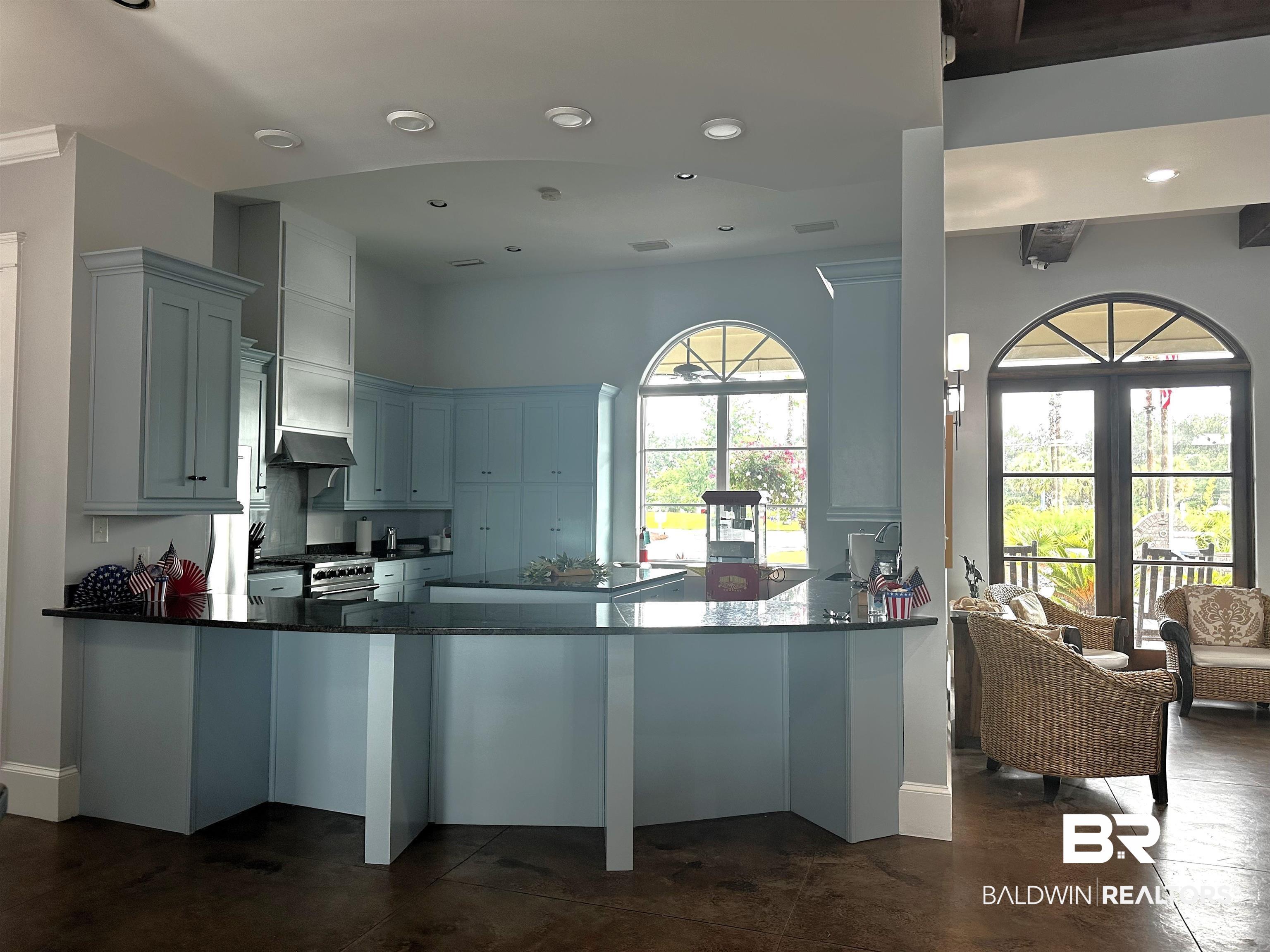 28238 Migratory Way Elberta, AL 36530 - Photo 57 of 58 Kitchen with dark stone counters, recessed lighting, a peninsula, a kitchen island, and stainless steel range