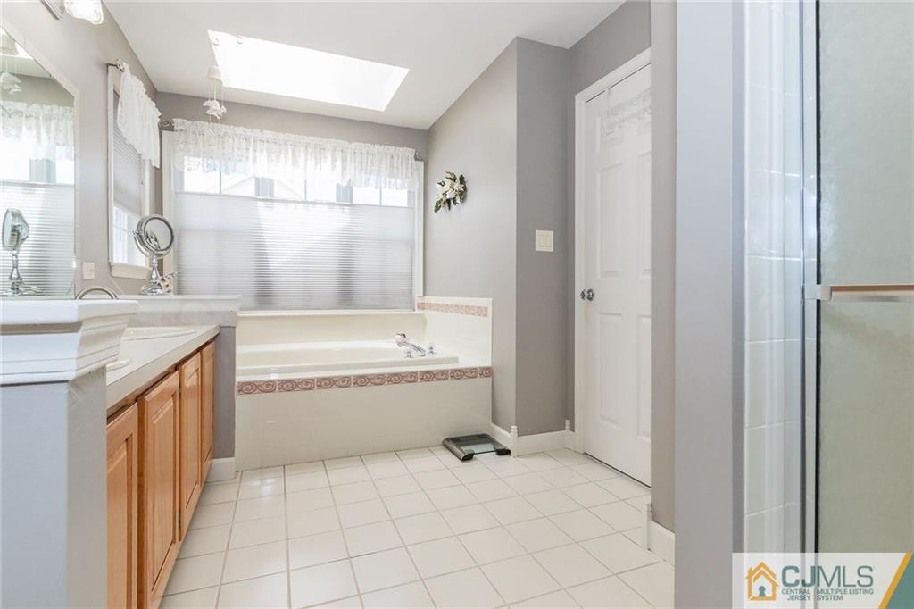 15 Crescent Road Old Bridge, NJ 08857 - Photo 12 of 19 a spacious bathroom with a tub sink and mirror