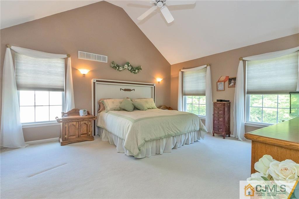 15 Crescent Road Old Bridge, NJ 08857 - Photo 9 of 19 a spacious bedroom with a bed and a chandelier