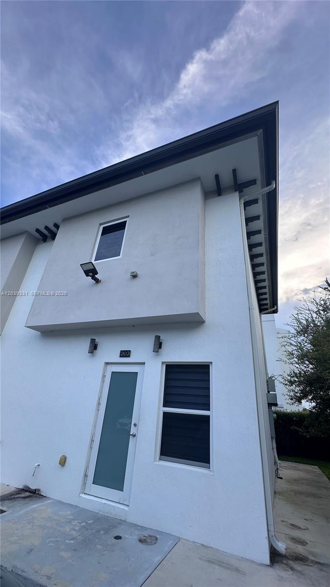 6410 Southwest 139th Avenue Road, Unit 203 Miami, FL 33175 - Photo 1 of 14 a front view of a house with garage