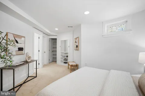 a bedroom with a bed and cabinets