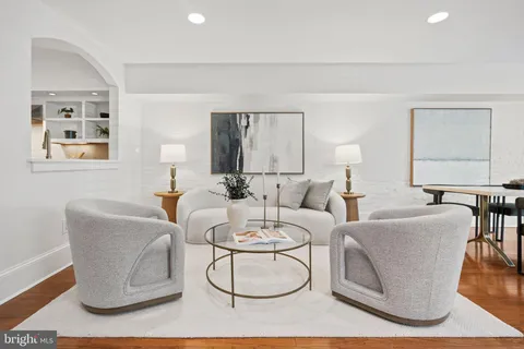 a living room with furniture a table and chair