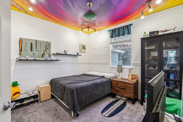 a bedroom with a bed and a chandelier