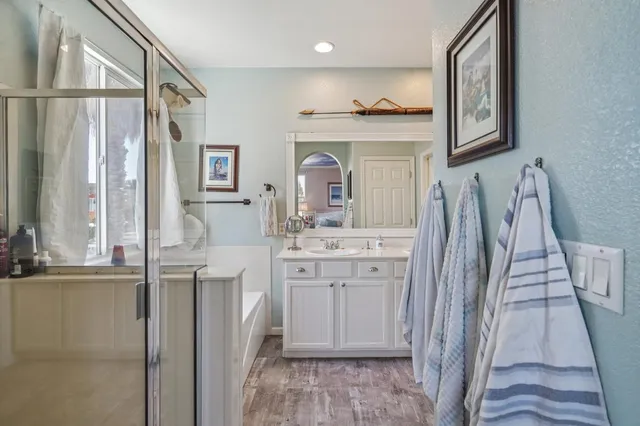 a bathroom with a tub shower and sink