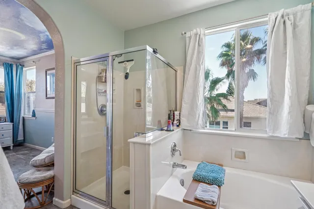 a view of a livingroom with workspace and a window