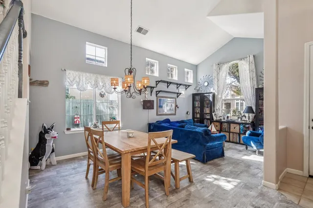 a view of a dining room with furniture and chandelier