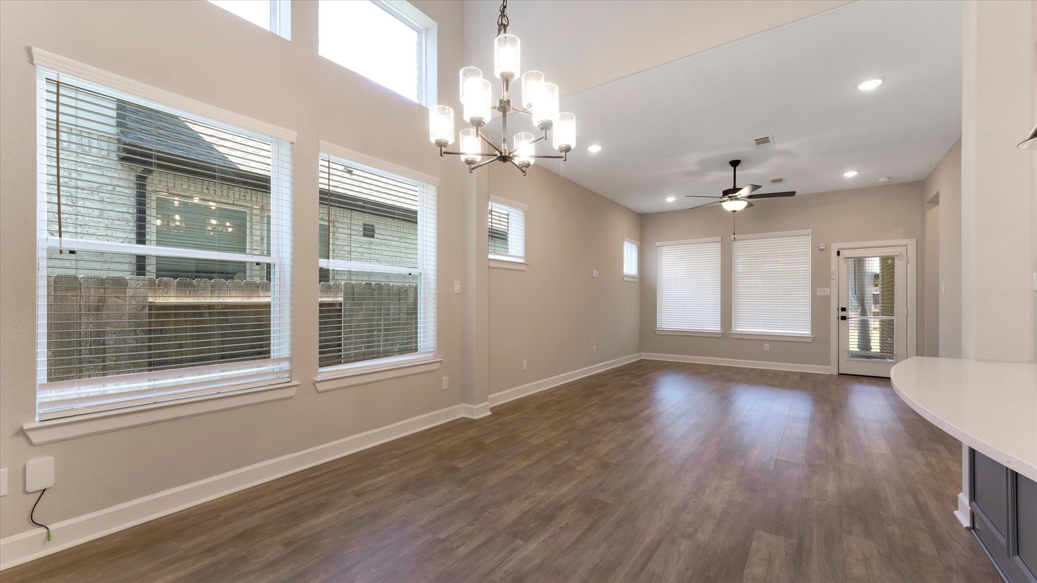 15607 Rising Wren Court Conroe, TX 77302 - Photo 7 of 40 a view of an empty room with wooden floor and a window