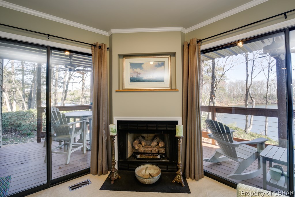 63 Mariners Point Lane, Unit A Hartfield, VA 23071 - Photo 4 of 29 Flanked by large sliding doors to the waterside deck, the fireplace is the focal point in the living room.