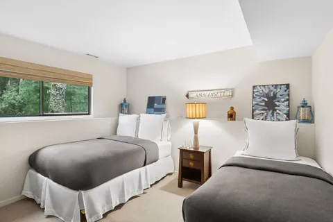 a bedroom with a bed and glass window