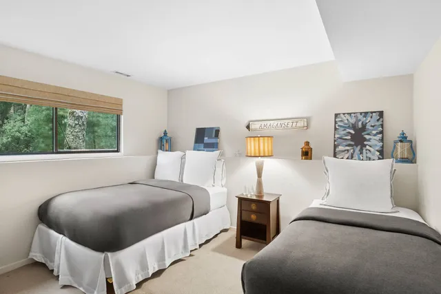 a bedroom with a bed and glass window