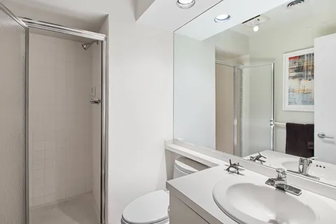 a bathroom with a sink toilet and shower
