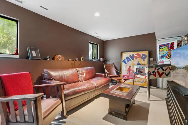 a living room with furniture a couch and a window