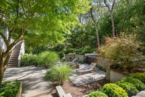 a view of backyard with plants and outdoor seating