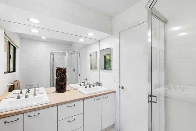 a bathroom with a double vanity sink mirror and double