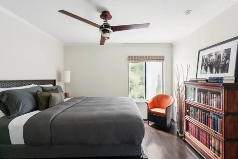 a bedroom with bed and a book shelf