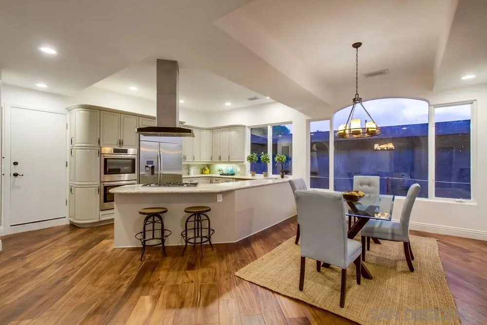 7411 Hillside Drive La Jolla, CA 92037 - Photo 11 of 25 a large kitchen with a table and chairs