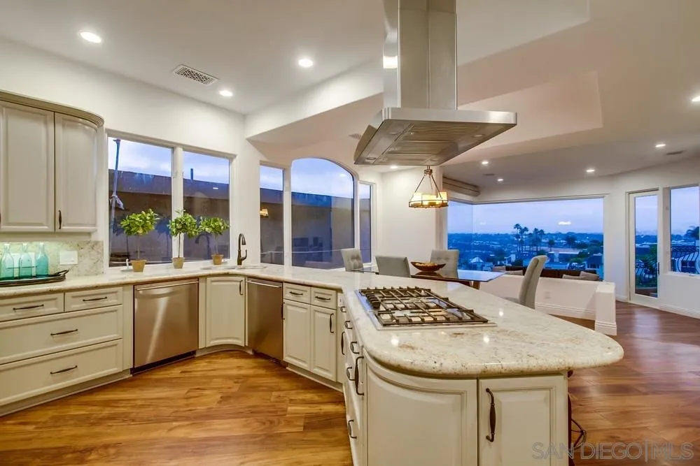 7411 Hillside Drive La Jolla, CA 92037 - Photo 14 of 25 a kitchen with stainless steel appliances kitchen island granite countertop a sink and cabinets