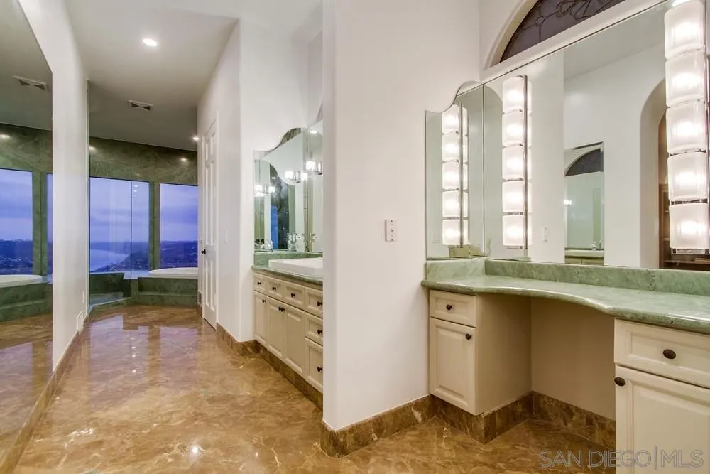 7411 Hillside Drive La Jolla, CA 92037 - Photo 19 of 25 a bathroom with a granite countertop sink and a mirror