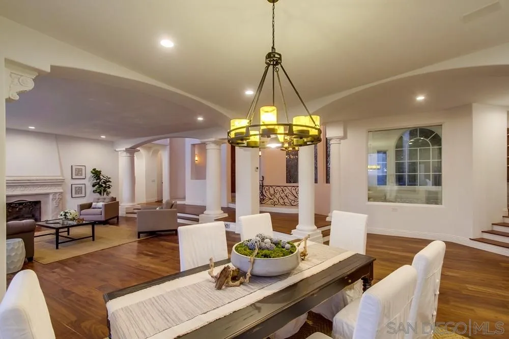 7411 Hillside Drive La Jolla, CA 92037 - Photo 4 of 25 a living room with couch a dining table and a chandelier