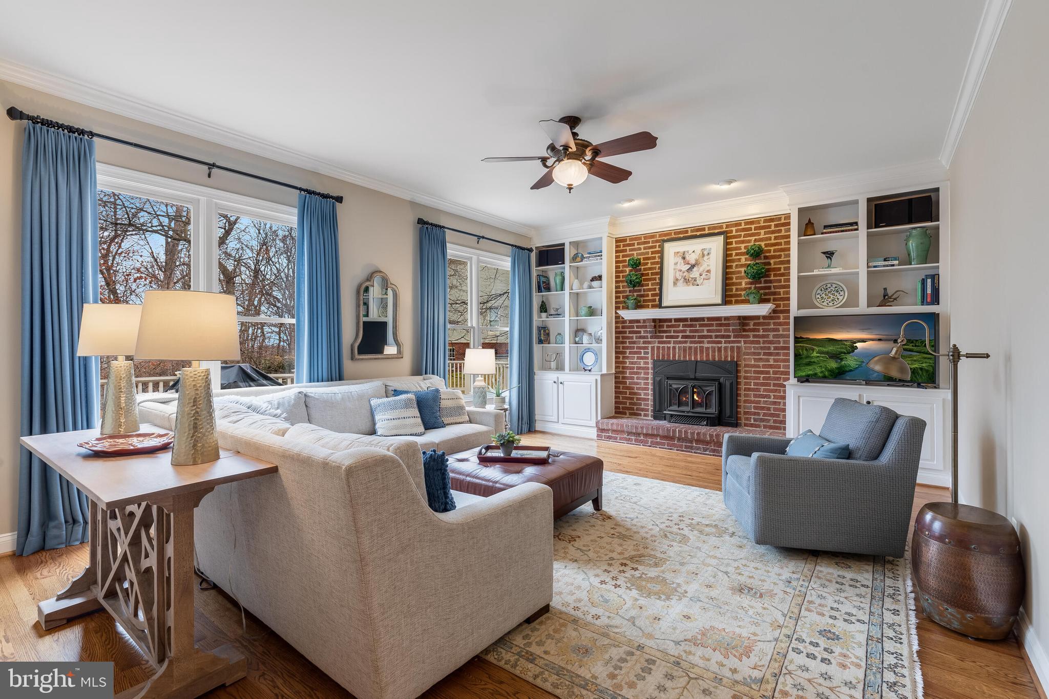 1181 Hawling Place Southwest Leesburg, VA 20175 - Photo 13 of 66 a living room with furniture a fireplace and a large window