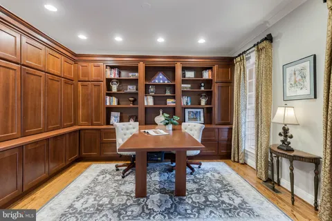 a dining room with furniture window and wooden floor