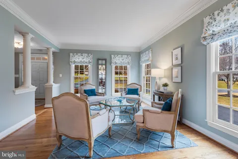 a view of a dining room with furniture large windows and wooden floor