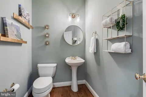 a spacious bedroom with a bed and wooden floor