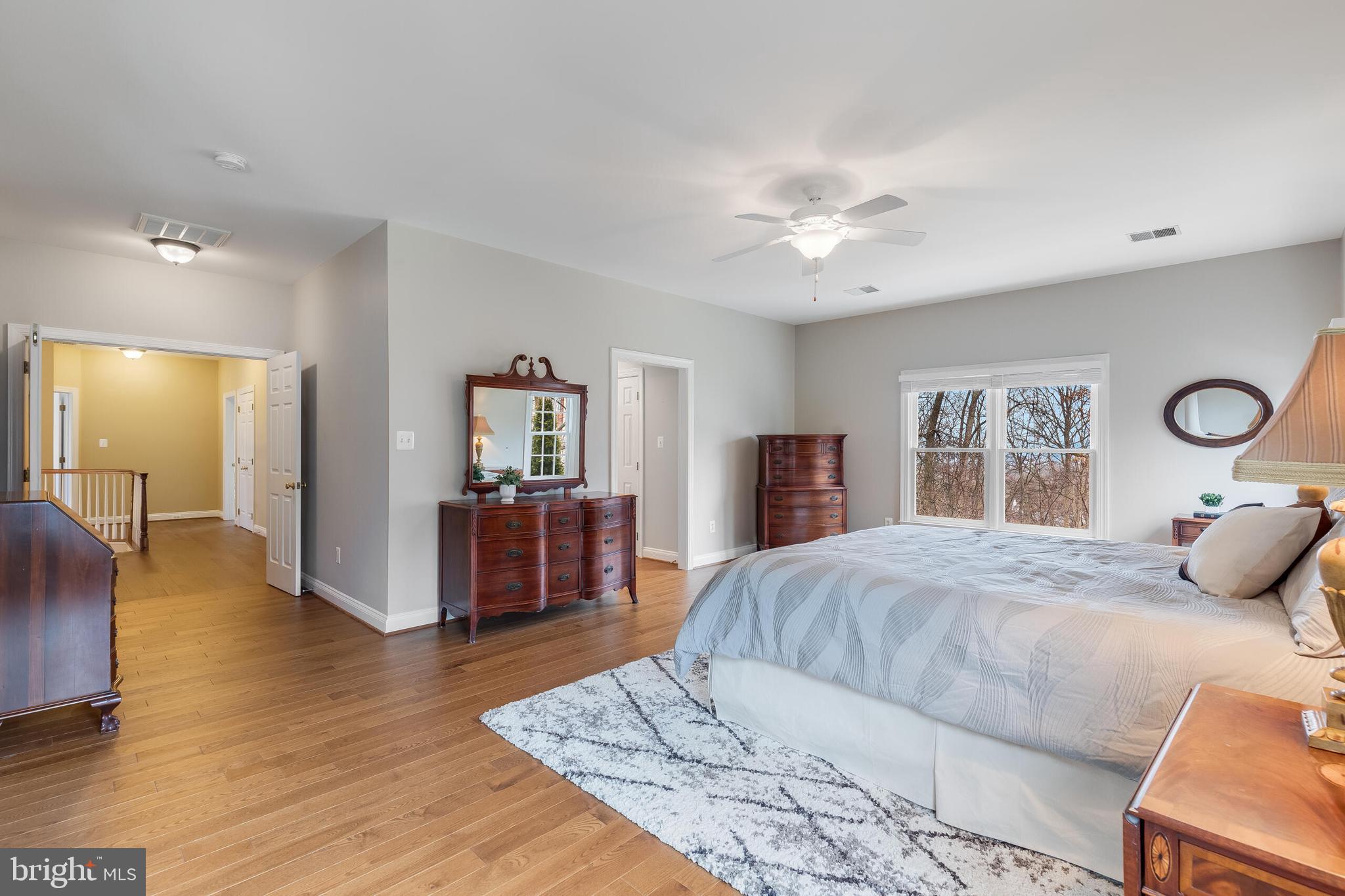 1181 Hawling Place Southwest Leesburg, VA 20175 - Photo 29 of 66 a bedroom with a large bed a chandelier and dresser