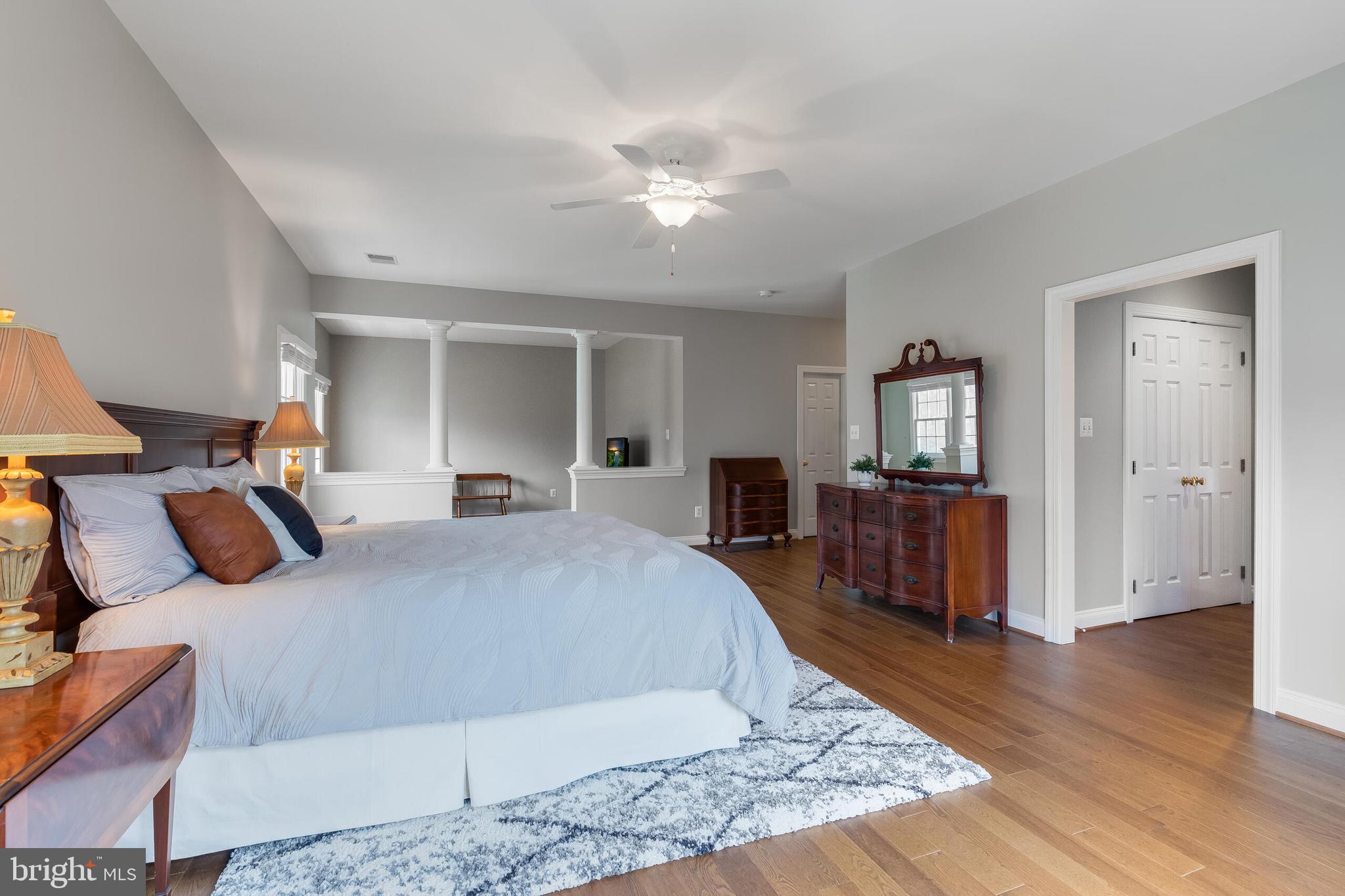 1181 Hawling Place Southwest Leesburg, VA 20175 - Photo 31 of 66 a large bedroom with a bed and wooden floor