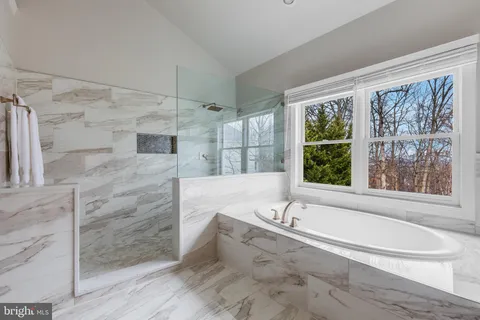a en suite bathroom with a double vanity sink and a mirror