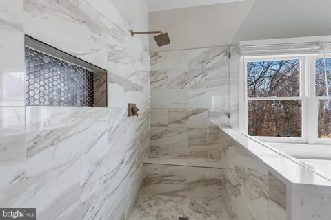 a white toilet sitting next to a bath tub shower