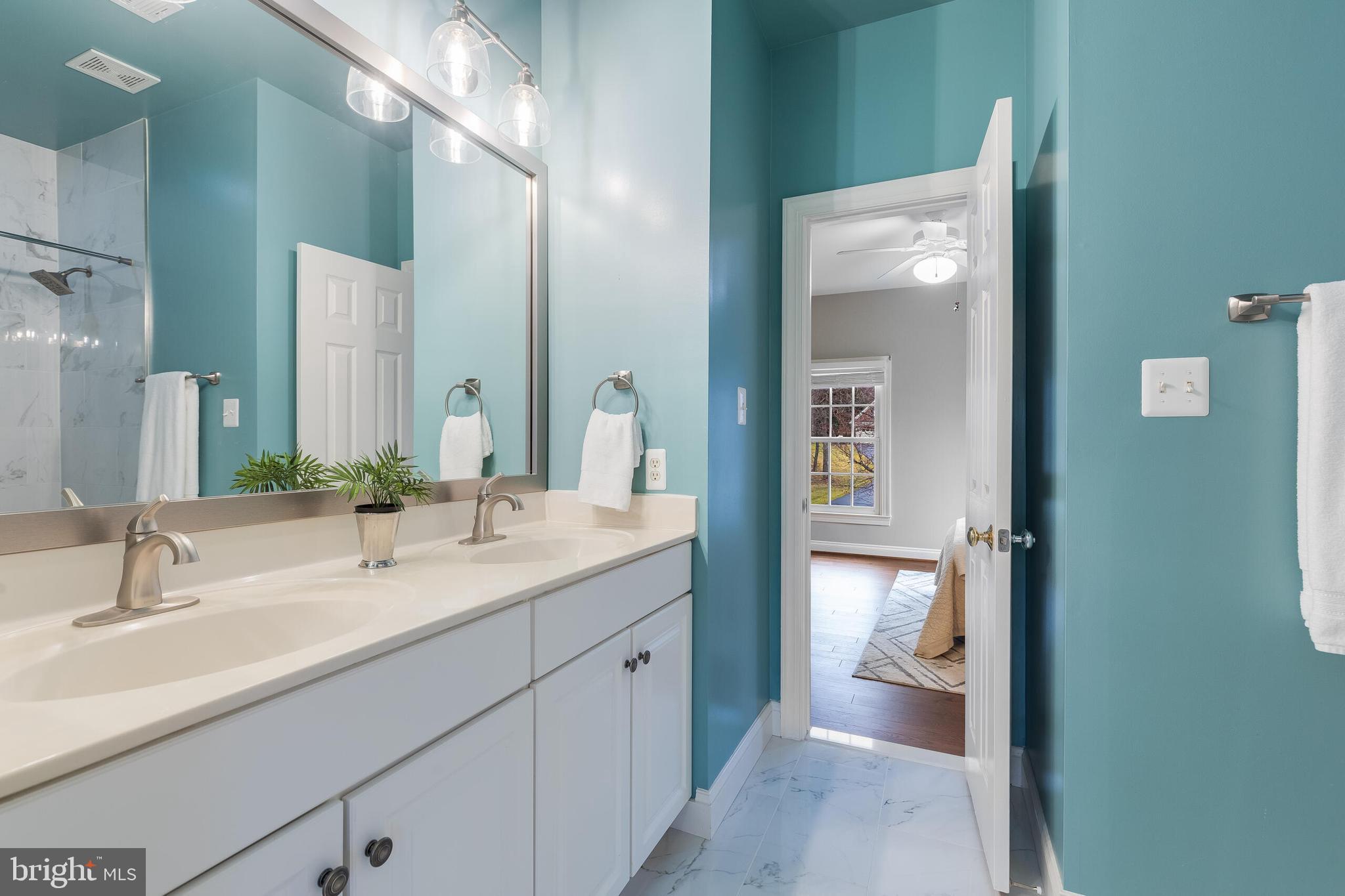 1181 Hawling Place Southwest Leesburg, VA 20175 - Photo 40 of 66 a en suite bathroom with a double vanity sink and a mirror