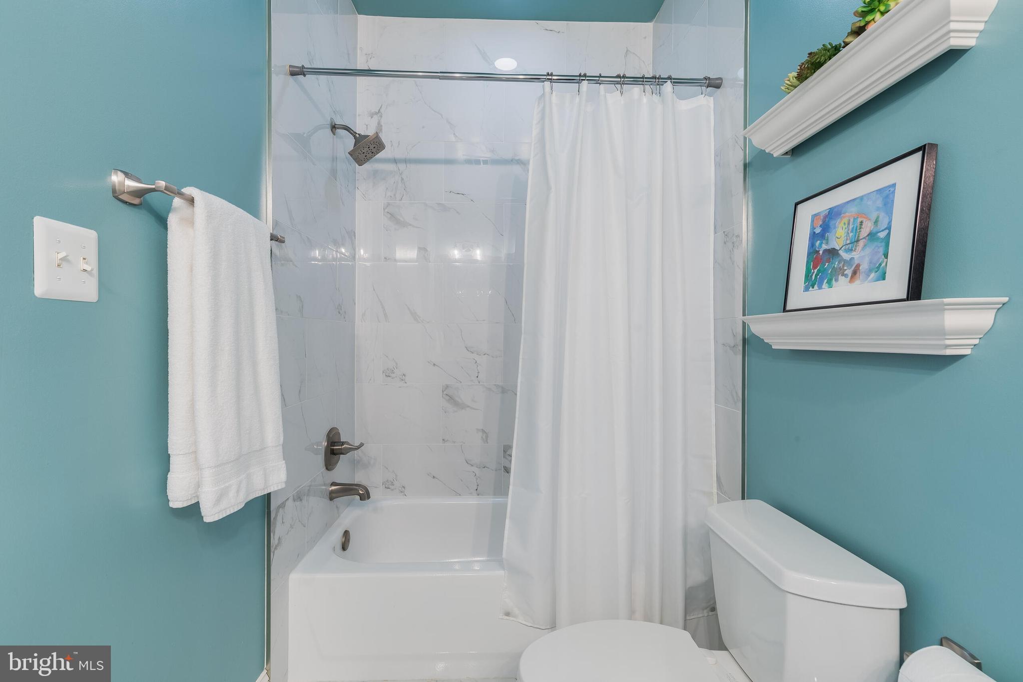 1181 Hawling Place Southwest Leesburg, VA 20175 - Photo 41 of 66 a white toilet sitting next to a bath tub shower