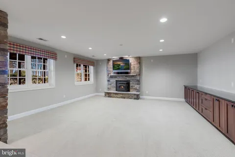 a view of backyard with a table and chairs with wooden fence and floor