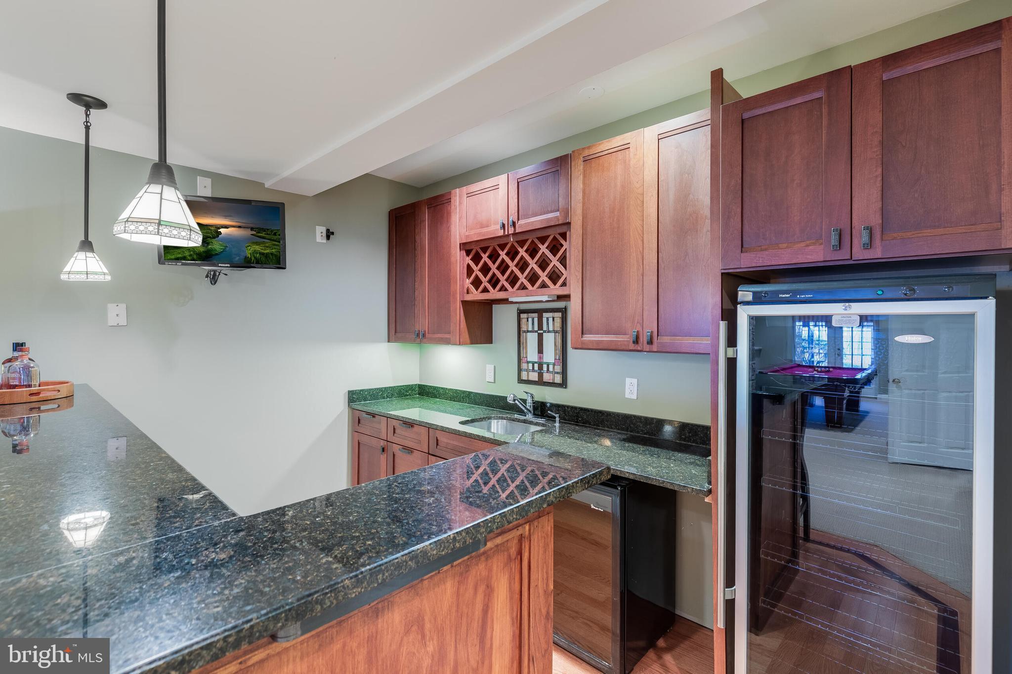 1181 Hawling Place Southwest Leesburg, VA 20175 - Photo 46 of 66 a kitchen with stainless steel appliances granite countertop a sink a stove and a wooden floors