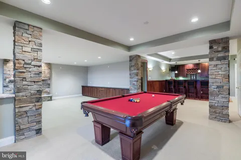 a view of backyard with swimming pool and green space