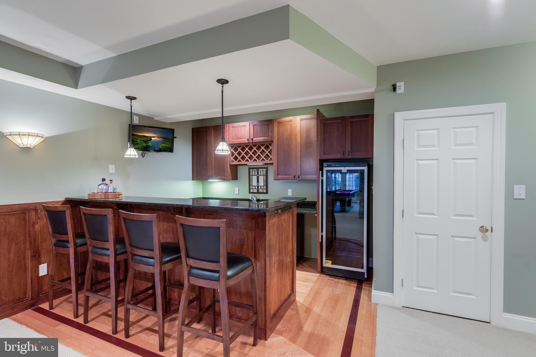 1181 Hawling Place Southwest Leesburg, VA 20175 - Photo 49 of 66 a kitchen with stainless steel appliances kitchen island granite countertop a refrigerator and microwave