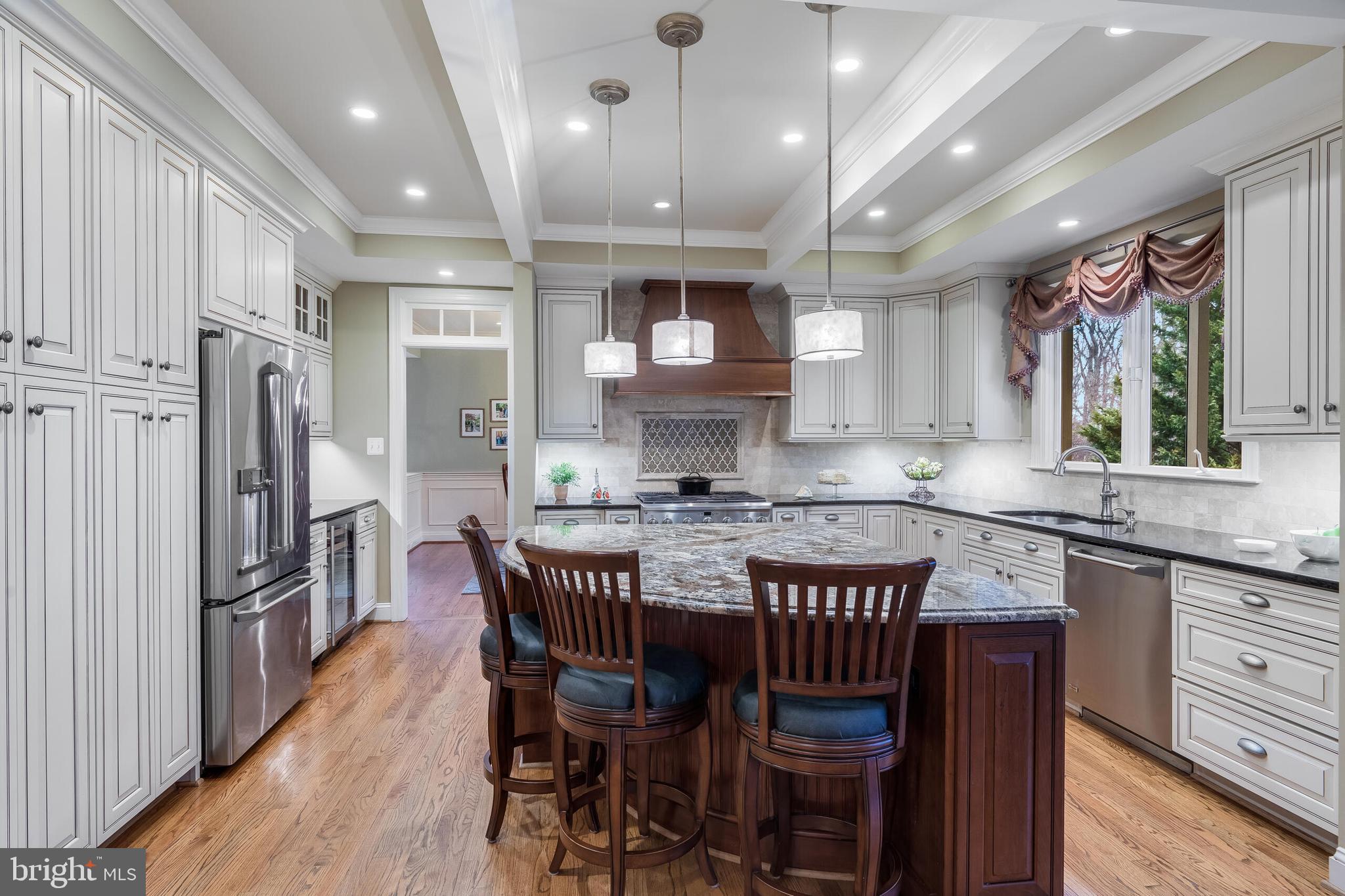 1181 Hawling Place Southwest Leesburg, VA 20175 - Photo 6 of 66 a kitchen with stainless steel appliances granite countertop a kitchen island a table and chairs in it