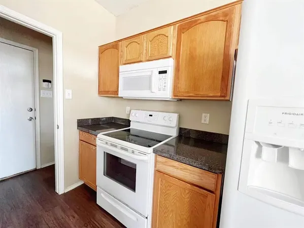a kitchen with a stove microwave and sink