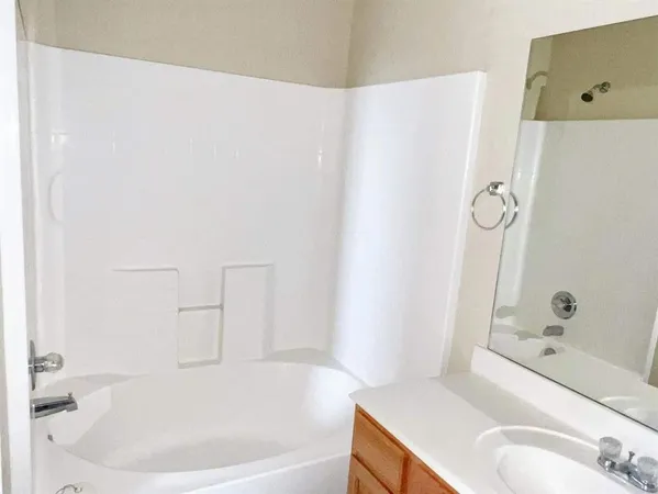 a white bath tub sitting next to a white sink