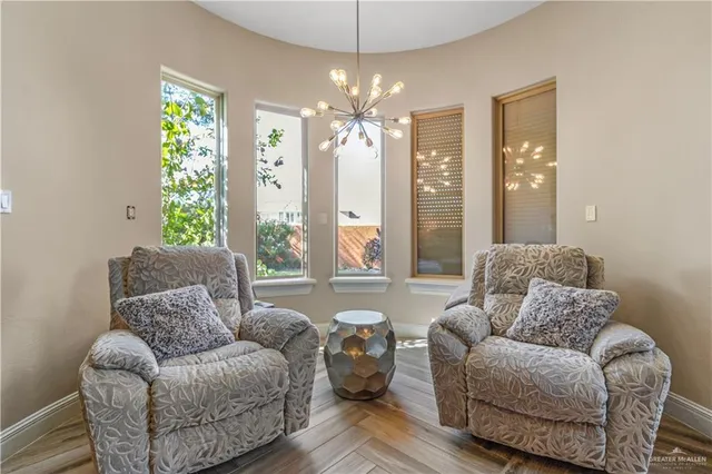 a living room with furniture and a chandelier