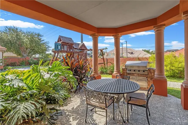a table and chairs in patio of the house