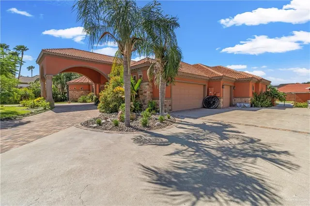 a view of a house with a yard and a plants