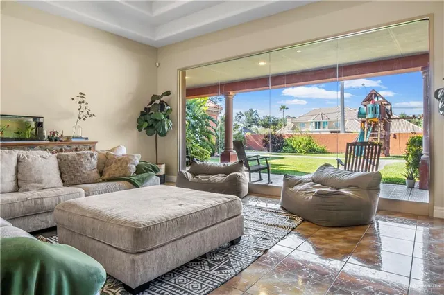 a living room with furniture and a floor to ceiling window
