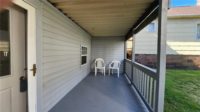 a view of a balcony with furniture