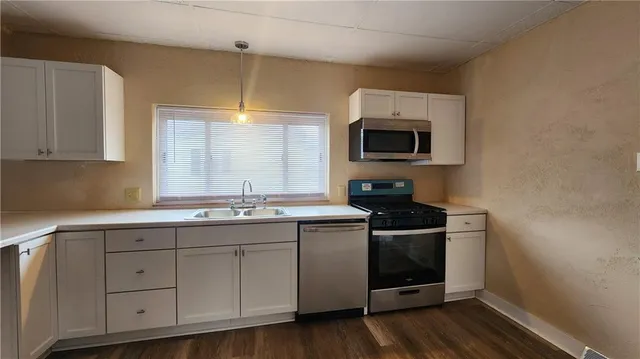 a kitchen with a sink and a microwave