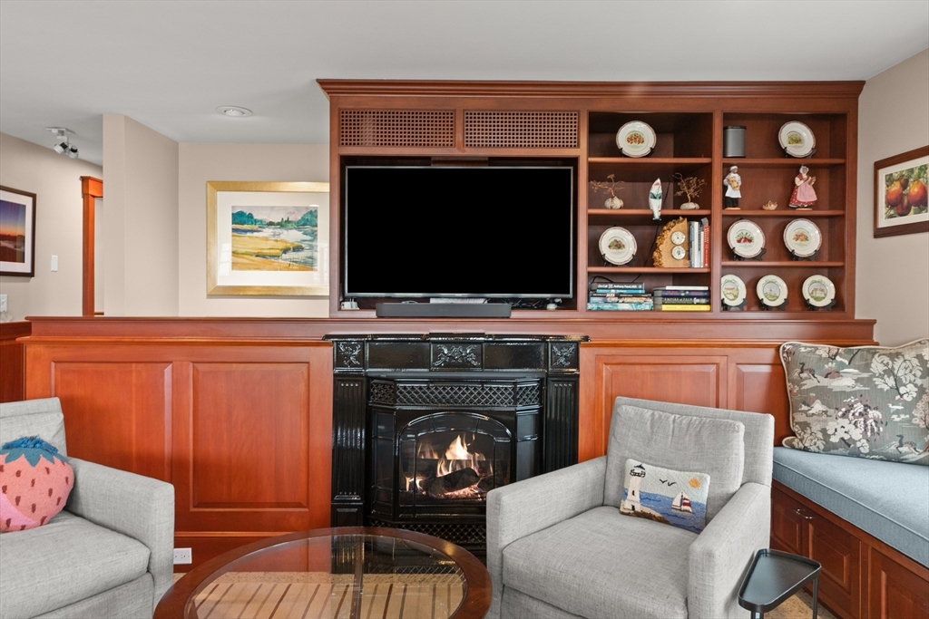 13 Phillips Avenue Rockport, MA 01966 - Photo 33 of 39 a living room with furniture a flat screen tv and a fireplace