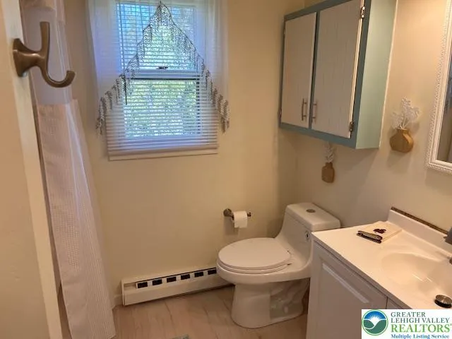 a white toilet sitting next to a bathroom sink
